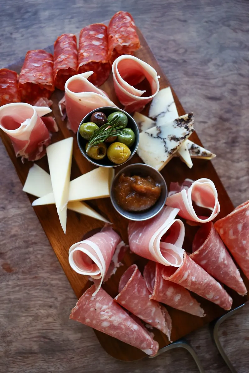 Antipasto board with cured meats, cheeses and olives