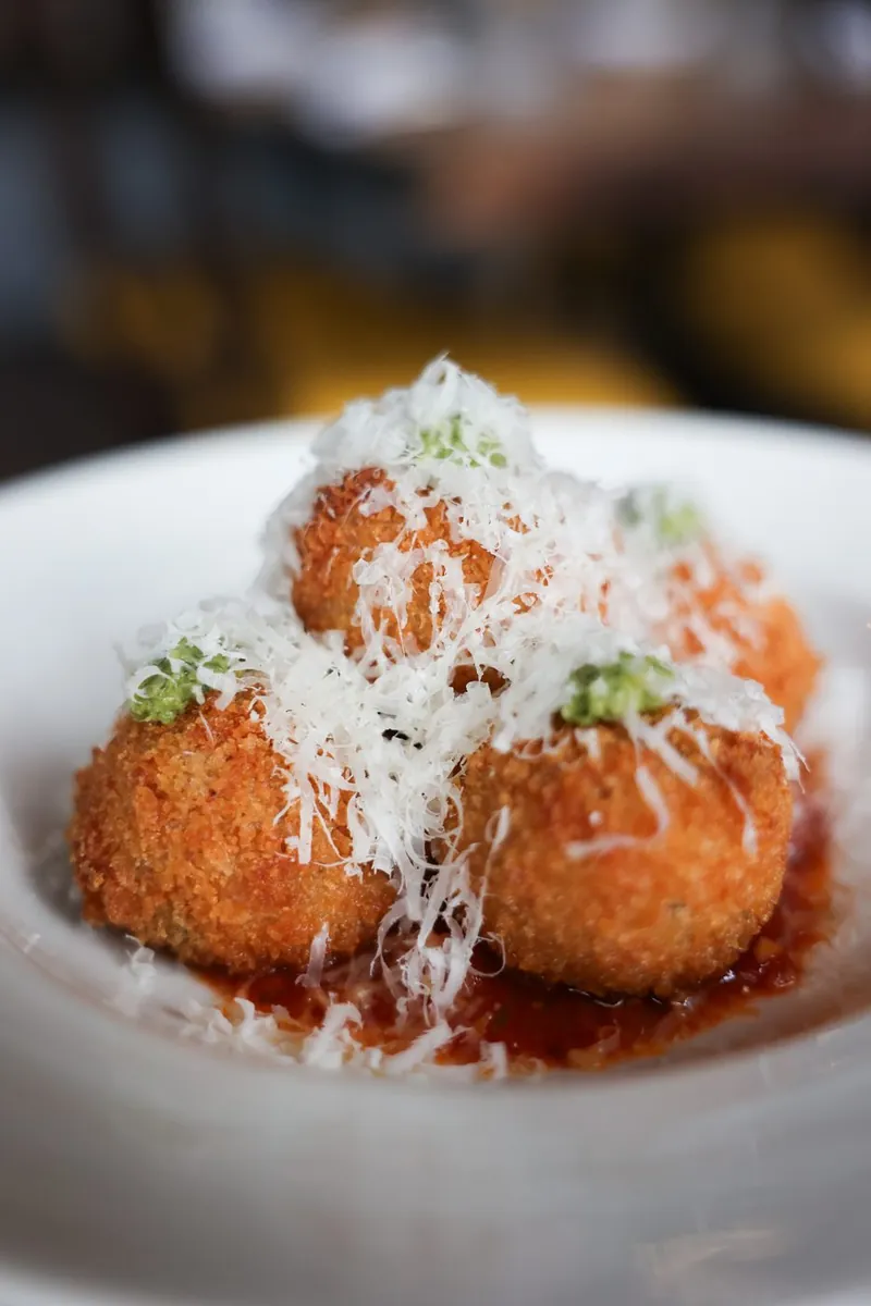 Arancini with tomato sugo and Parmigiano Reggiano