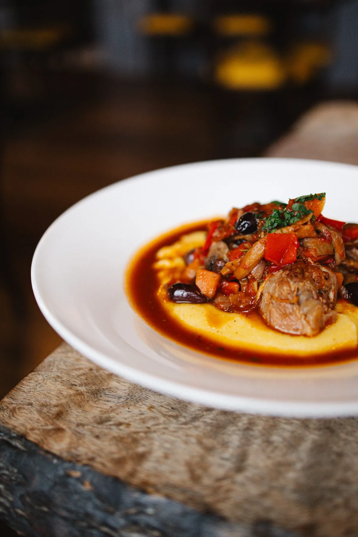 Braised pork with olives over soft polenta