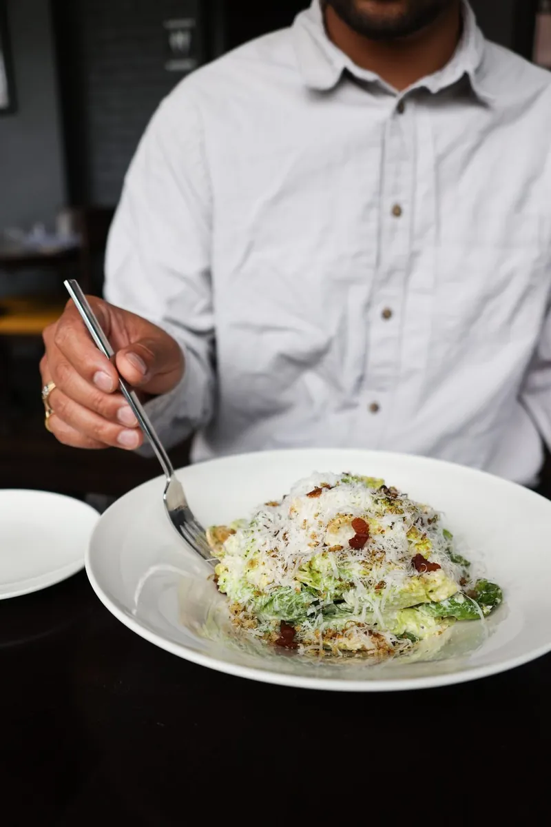 Baby gem caesar with double smoked bacon, served tableside