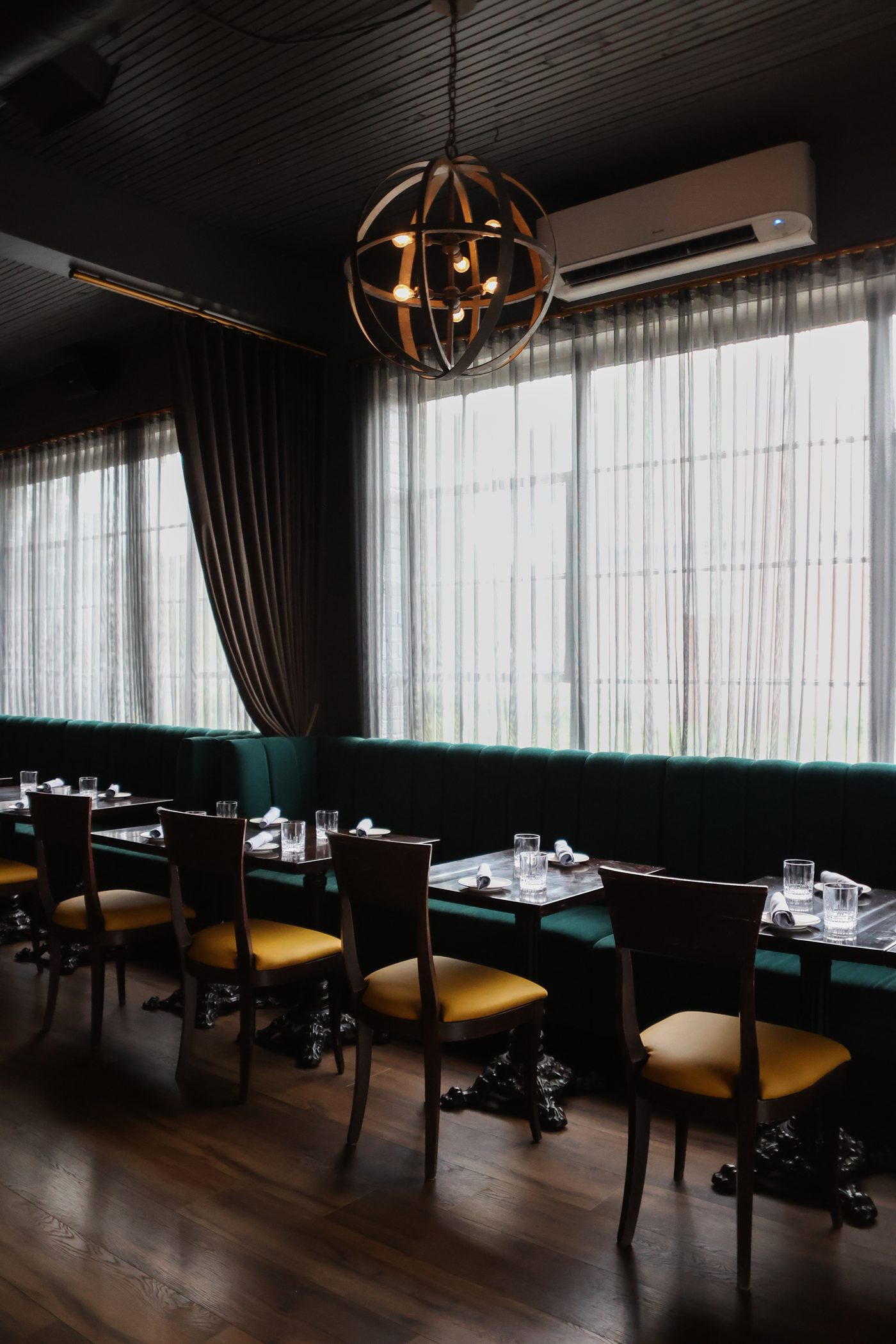 Emerald banquette seating set for a group at Tulia Osteria