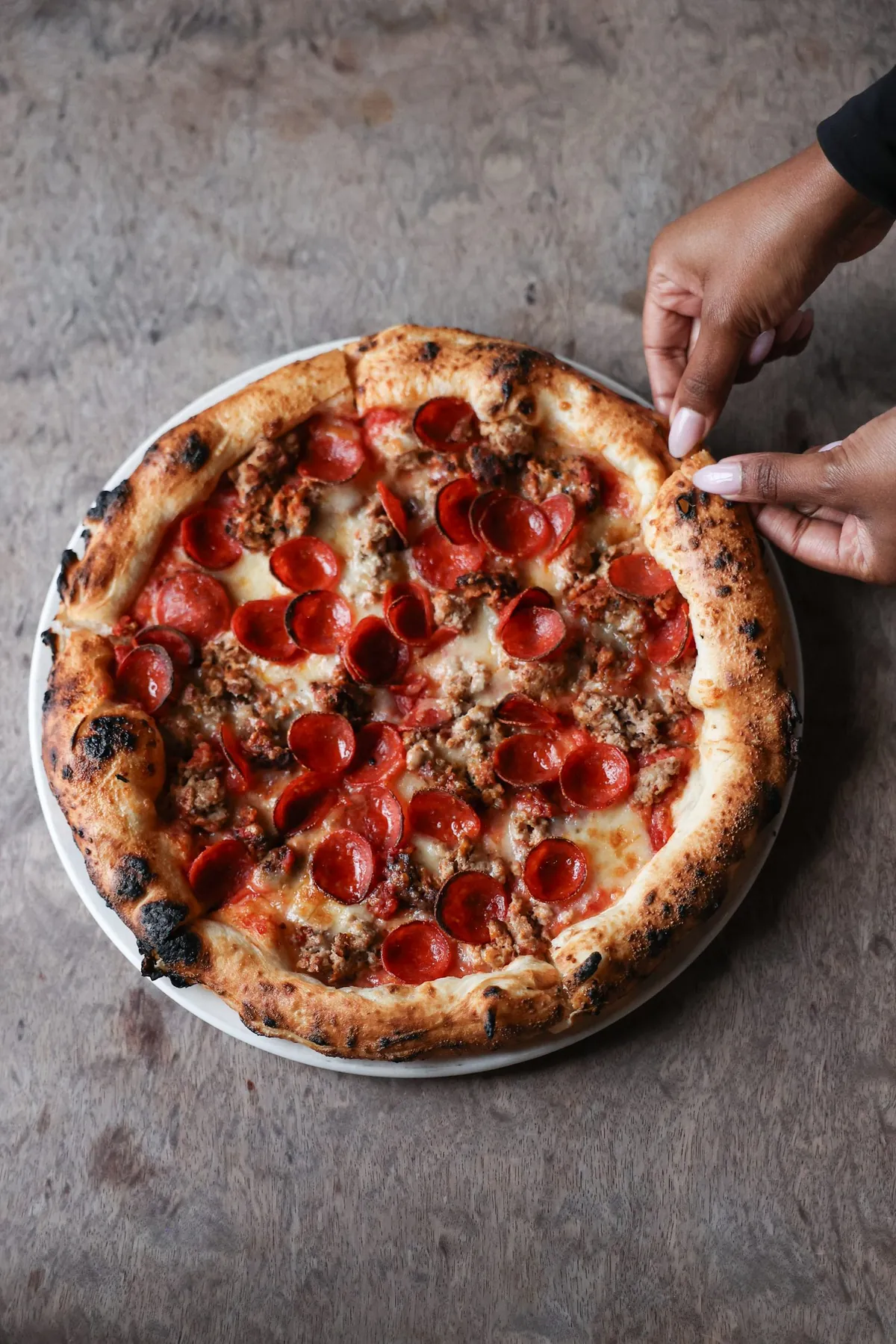 Pepperoni and sausage Neapolitan pizza from the wood oven