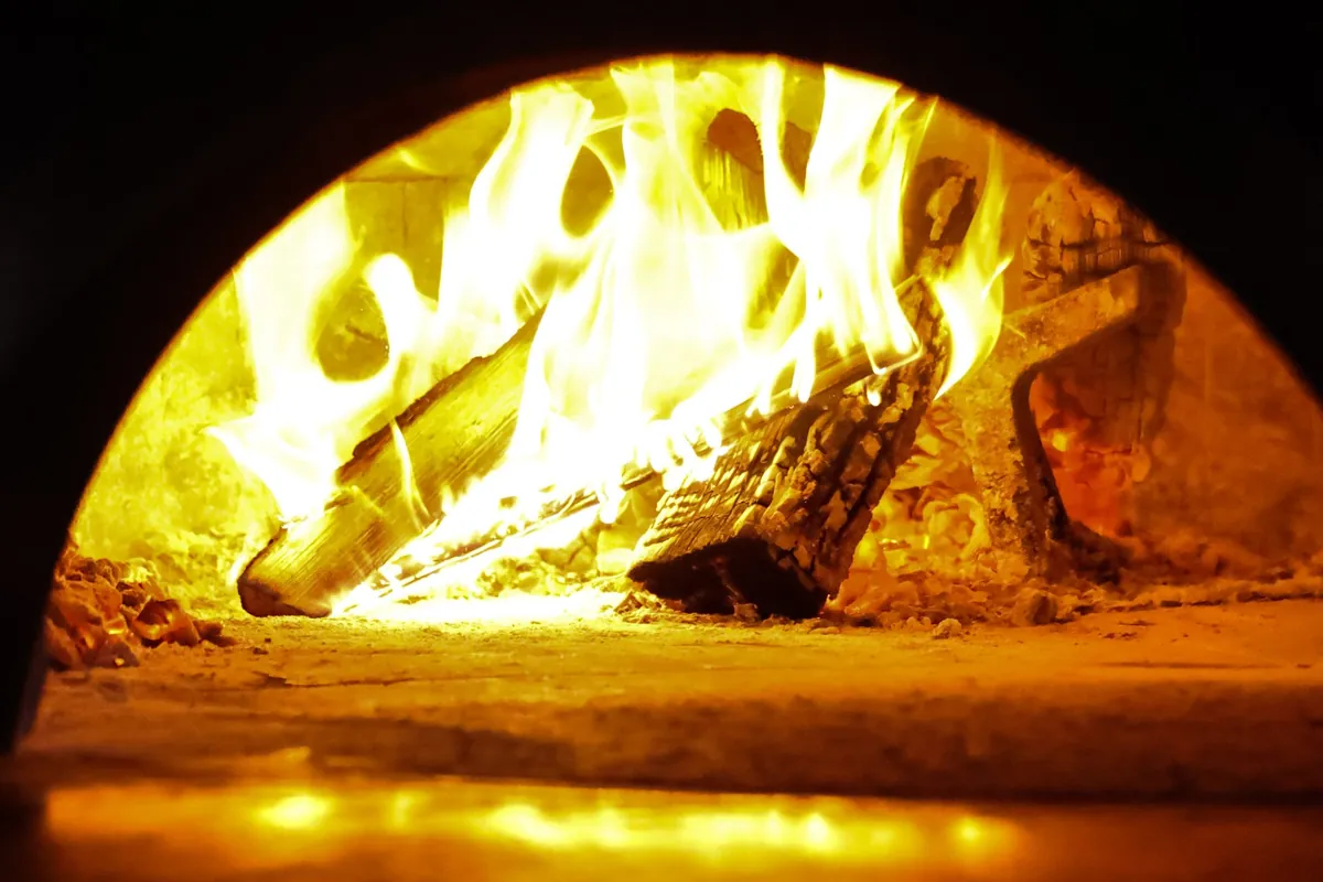 Live fire in the wood-fired pizza oven at Tulia Osteria in Leslieville, Toronto
